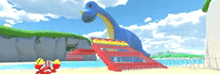 a blue dinosaur is sitting on a red ramp on a beach