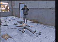 a man laying on the floor with a gun on the floor