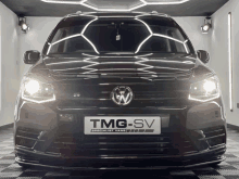 a black van with a tmg sv sign on the front