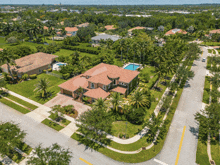 an aerial view of a residential neighborhood with a large house in the middle