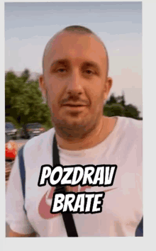 a man wearing a white nike shirt with the words pozdrav brate on it