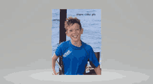 a young boy wearing a blue shirt that says ocean on it