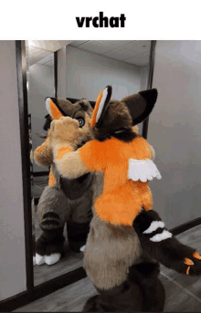 a furry fox is hugging another furry fox in front of a mirror with the word vrchat above it