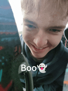 a boy with a ghost and the word boo on the bottom