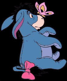 eeyore from winnie the pooh has a pink butterfly on his head .