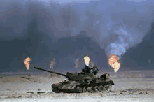 a military tank is driving through a field of fire .