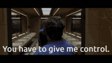 a man in a blue shirt is standing in a bathroom with the words " you have to give me control "