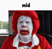 a mcdonald 's clown is crying with his eyes closed and a bow tie .