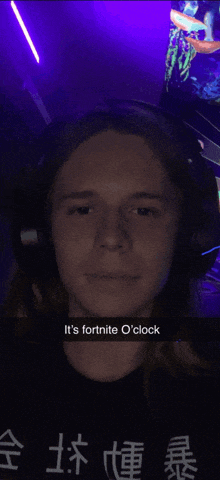 a man wearing headphones and a shirt that says it 's fortnite o clock