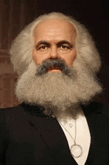 a man with a beard and mustache is wearing a suit and tie and a watch .