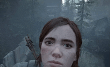 a close up of a woman 's face in a video game with an arrow .