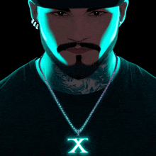 a man with a beard wears a necklace with a glowing x on it