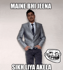 a man in a suit and tie is standing next to a troll face that says maine bhi jeena sikh liya akela