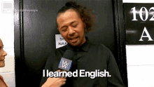 a man is talking into a microphone and saying `` i learned english . ''