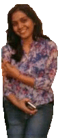 a woman in a floral shirt is holding a cell phone and smiling