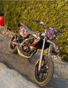 a red and black dirt bike with the word rk on the front