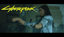 a woman is standing in front of a cyberpunk 2077 poster