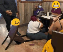 a woman is sitting on the floor in a restaurant while a chair is broken .