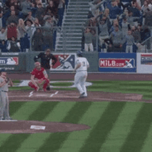 a baseball game is being played in front of a milwaukee sign