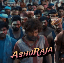 a man in a red and white shirt is standing in front of a crowd of people with the word ashuraja on the bottom .