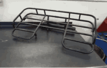 a black metal rack is sitting on a black table