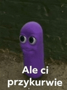 a purple worm with big eyes is standing in front of a brick wall and says `` ale ci przykurwie '' .