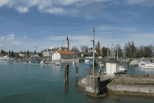 boats are docked in a harbor with a church in the distance