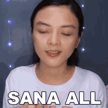 a woman is making a funny face with her eyes closed and the words sana all written on her face .