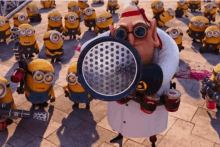 a group of minions are gathered around a cartoon character holding a megaphone