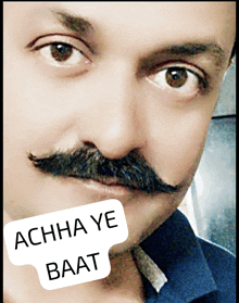 a close up of a man 's face with a sticker that says achha ye baat on it