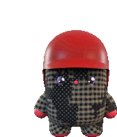 a stuffed animal with a red helmet on it 's head