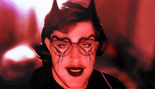 a man with devil horns on his head and glasses on