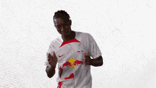 a man wearing a white jersey with red bulls on it