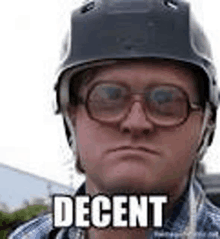 a man wearing a helmet and glasses is making a face and says decent .