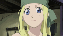 a girl with blonde hair and blue eyes is wearing a green bandana around her head