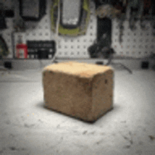 a small wooden block is sitting on top of a concrete table .