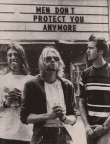 three men are standing in front of a sign that says men don t protect you anymore