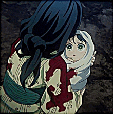 a woman is holding a baby in her arms with blood on her sleeves