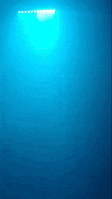 a blue light is shining on a dark blue background