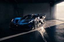 a bugatti sports car is parked in a dark garage