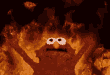 elmo from sesame street is surrounded by fire