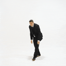 a man in a suit and tie is standing in front of a white background with the word folks written on it