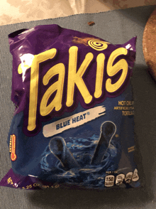 a bag of takis blue heat chips is sitting on a table