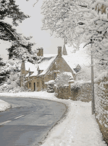 a snowy landscape with a stone building in the background