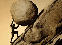 a man is pushing a large rock up a cliff