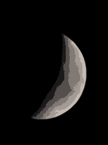 a close up of a crescent moon against a black sky