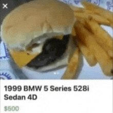 a picture of a hamburger and french fries on a plate .