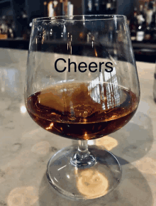 a glass of cheers sits on a counter