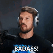 a man with a beard wearing headphones and a shirt that says badass .