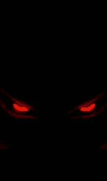 a close up of a pair of red eyes glowing in the dark .